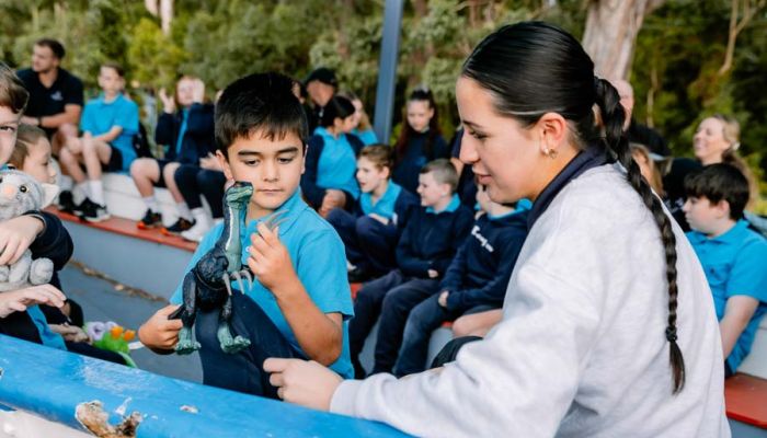 A staff member offering support to a younger student.